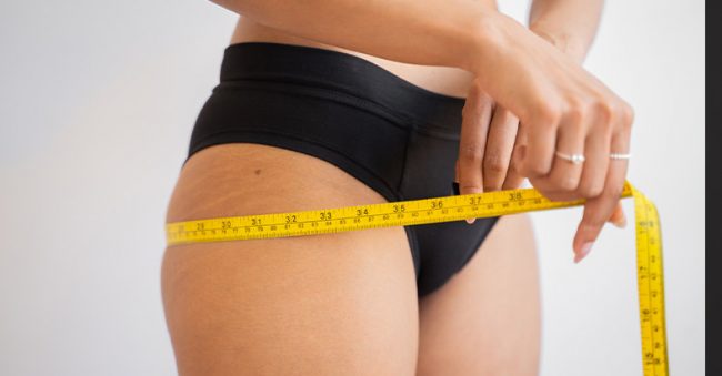 woman-measuring-hips-OFW image of woman measuring weight loss