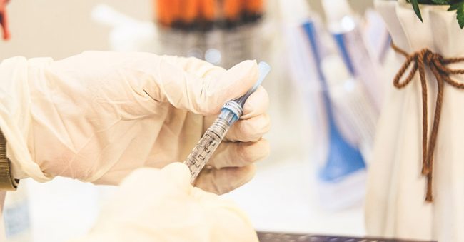 image of hand holding hcg injection