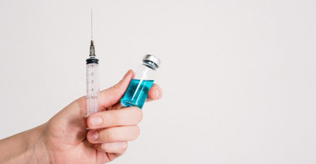 image of hand holding hcg injection